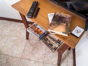 a wooden table with magazines and a remote control at Spacious Apartment in Espinho with Fireplace, 87 sqm in Espinho