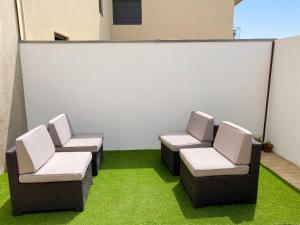 two chairs sitting in a room with green grass at Spacious Apartment in Espinho with Fireplace, 87 sqm in Espinho +20 photos