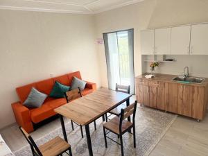 a living room with an orange couch and a table at Аска in Imeni Kirova