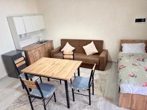 a small living room with a table and a couch at Аска in Imeni Kirova