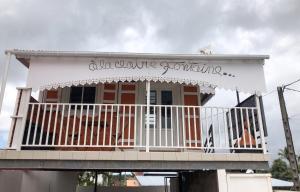 a building with a balcony with a sign on it at Studio confortable à Sainte-Suzanne, 20 m², balcon in Sainte-Suzanne