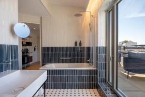 a bathroom with a bath tub and a shower at Urban Hive Paris in Paris +30 photos