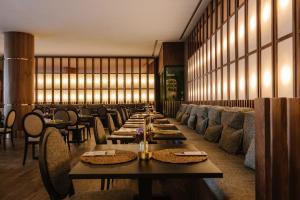 a dining room with long tables and chairs at Occidental Casablanca Medina in Casablanca +32 photos