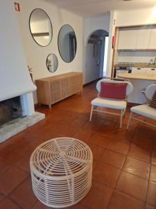 a room with two chairs and a table and mirrors at Solar Pinheiros RC in Vilamoura +11 photos
