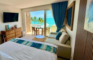 a bedroom with a bed and a view of the ocean at So KohKoon Beach Resort in Bangrak Beach +145 photos