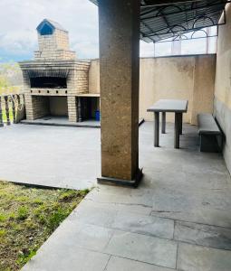a table and bench sitting on a patio at Yeganyan's Home in Ashtarak +5 photos