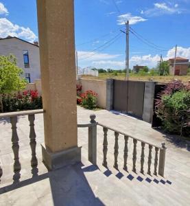 a stone railing on a porch with a column at Yeganyan's Home in Ashtarak