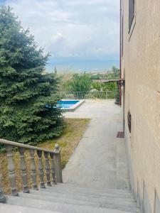 a walkway next to a building with a pool at Yeganyan's Home in Ashtarak