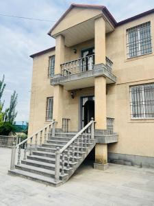 a building with a staircase in front of it at Yeganyan's Home in Ashtarak