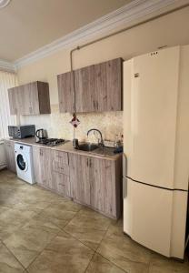 a kitchen with a sink and a white refrigerator at Yeganyan's Home in Ashtarak