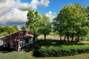 a small building in the grass with trees at Best Western Parkhotel Brehna-Halle in Brehna