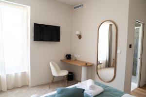a bedroom with a mirror and a bed and a desk at Domaine de Beaucens in Beaucens