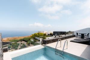 a swimming pool on the roof of a house at SantAnna Luxury Suites in Imerovigli