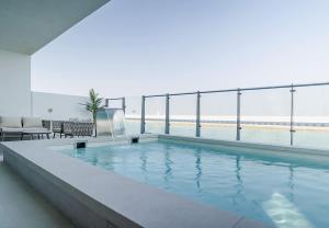 a swimming pool on the top of a building at Blausee Beachfront Villa with Private Pool in Al Ḩamrīyah +122 photos