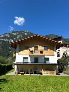 a house being built with mountains in the background at B&B Te Nìf in Predazzo