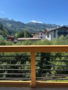 a wooden bench with a view of the mountains at B&B Te Nìf in Predazzo