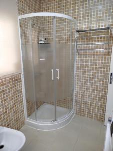 a shower with a glass door in a bathroom at Aires de Chipiona Apartamento A in Chipiona