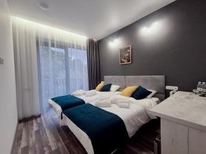 a bedroom with a large bed and a large window at Musa Hotel in Yeghegis