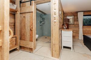 a bathroom with a toilet and a sink in a room at Owl Barn in Little Milton +83 photos