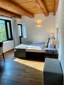 a bedroom with a bed and a large window at Hardthaus Gästezimmer in Kraiburg am Inn