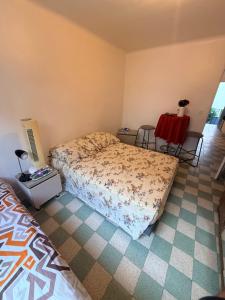 a bedroom with a bed and a table and chairs at Twin room in Nice
