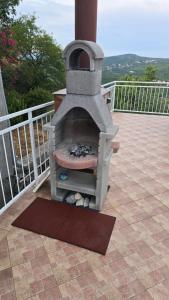 a stone oven sitting on top of a patio at Apartment Labin in Labin