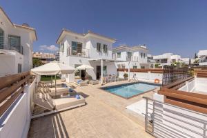 a large white house with a swimming pool at Fig Tree Beach Villa Two in Paralimni