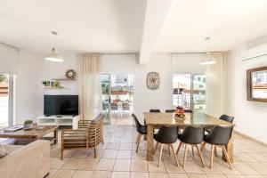 a living room with a table and chairs at Fig Tree Beach Villa Two in Paralimni