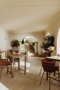 a room with tables and chairs and a staircase at Le Suites sul Mare di Esterina in Civitavecchia