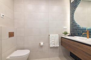 a bathroom with a toilet and a sink and a mirror at Bia in Almancil +16 photos