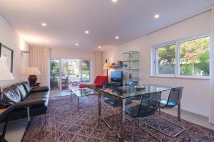a living room with a table and a couch at Bia in Almancil
