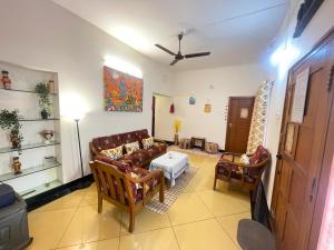 a living room with a couch and chairs and a table at Neha's Homestay in Mysore +36 photos