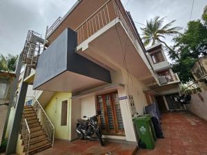 a motorcycle parked in front of a house at Neha's Homestay in Mysore