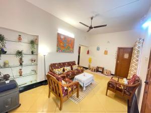 a living room with couches and a table at Neha's Homestay in Mysore