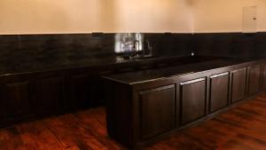 a kitchen with a large black counter top at Parrot Perch Villa Dickwella in Dickwella +17 photos