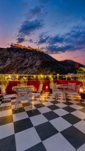 a patio with tables and chairs on top of a building at Nahargarh view Hotel in Jaipur