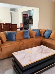 a brown couch with a table in a living room at Selah House in Harare