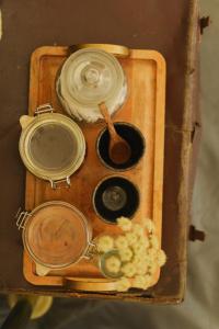a wooden box with a pot and a lid and a spoon at Devon Belltents - Beesands in Kingsbridge