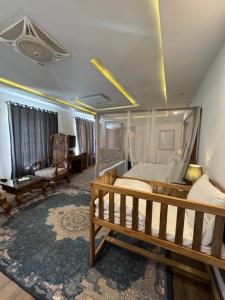 a bedroom with a canopy bed and a living room at Hotel Reego in Skardu +75 photos