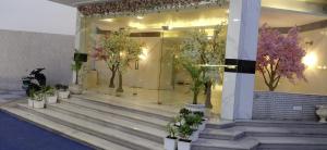 a bunch of potted plants on the steps of a building at Landmark Resort in Sonīpat