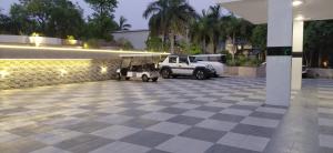 two white golf carts parked in a parking lot at Landmark Resort in Sonīpat