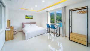 a bedroom with a bed and a desk and a window at Gapyeong Boreum-Dal Poolvilla in Gapyeong