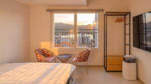 a bedroom with a bed and a large window at Gapyeong Boreum-Dal Poolvilla in Gapyeong