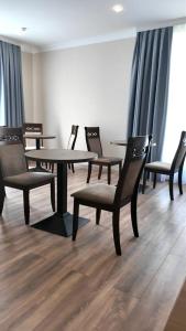 a group of tables and chairs in a room at Elegance Hotel Osh in Osh