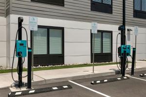 a parking lot with two electric meters in front of a building at StudioRes by Marriott Greensboro Airport in Greensboro