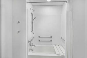 a shower in a bathroom with white walls at StudioRes by Marriott Greensboro Airport in Greensboro +17 photos