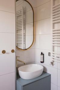 a bathroom with a sink and a mirror at Domki & Jacuzzi w Centrum Soliny 885-053-839 in Solina +25 photos