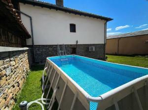 a swimming pool in a yard next to a building at Guesthouse Dryanovo in Dryanovo