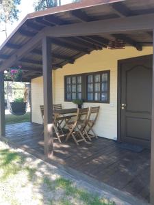 a patio with a table and chairs on it at Cozy house for your holidays in Bernāti