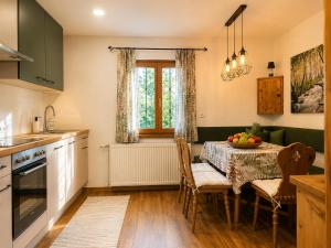 a kitchen and dining room with a table and chairs at Skoff Original Holzhaus in Eckberg +5 photos
